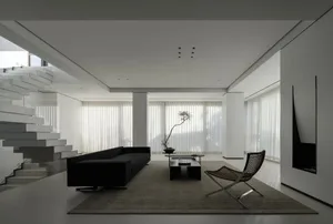 A modern minimalist living room with concrete, glass, and wood elements.