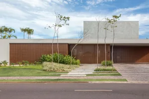 A modern residential entrance featuring concrete walls and glass elements.