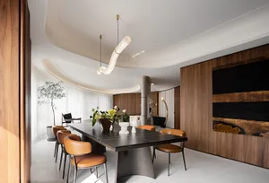 Modern industrial dining room with wooden accents and minimalist design.