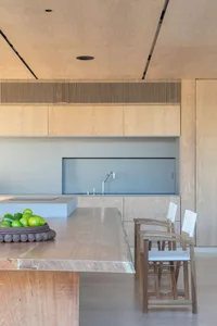 Modern kitchen with wooden countertop and stools