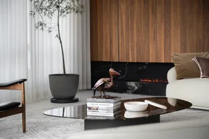 Modern living room with marble table, wooden wall, and leather sofa