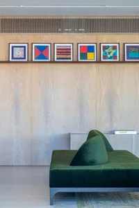 A modern lobby interior featuring an accent wall adorned with abstract art pieces.