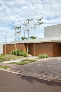 Modern residential exterior featuring sandstone and cement materials.