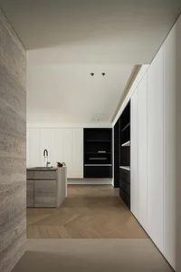 Minimalist residential kitchen featuring textured concrete kitchen island