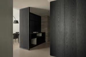 A modern office space featuring dark wood elements and minimalist design.