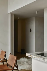 Modern interior design featuring leather, marble, and wooden elements.