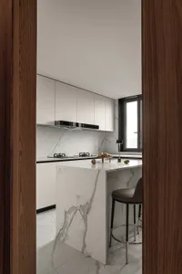 Modern minimalist kitchen with marble countertops and minimalist design features.