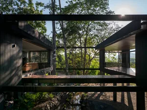 Modern residential exterior with black cladding and glass windows