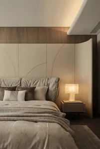 A modern bedroom featuring a comfortable bed with fabric bedding, surrounded by a minimalist design and ambient lighting.