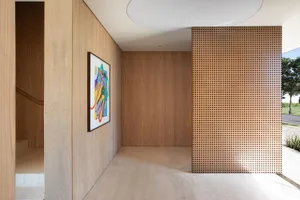 Modern interior with wooden walls, perforated panel, and concrete floor