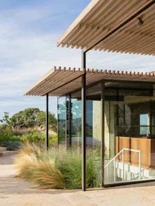 Modern residential exterior featuring wooden and glass materials.