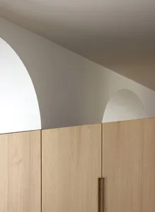 A close-up view of minimalist wooden moldings with light-colored wood in a minimalist setting.