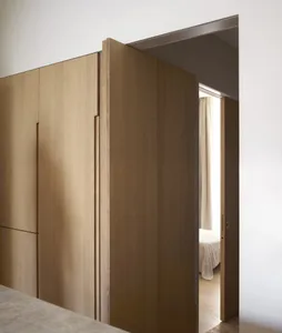 a minimalist residential interior with wooden details, featuring a bedroom with curtains opened.