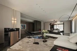 Modern living room with white furniture, dark wood floor, and minimalist decor.