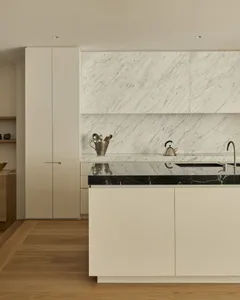 Modern kitchen with marble countertops and black accents