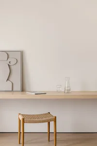 Minimalist workspace featuring wood and glass materials.
