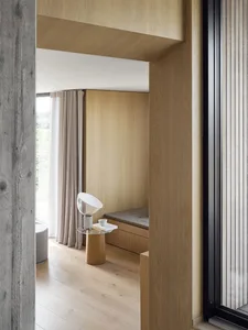 A minimalist residential space featuring wooden paneling, with a clean and modern aesthetic.