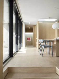 Modern interior design featuring wooden floors, glass doors, and a minimalist aesthetic.