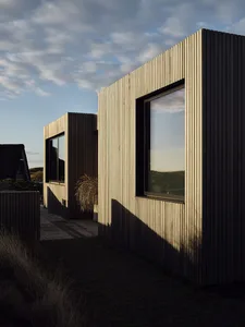 Modern residential building with wooden exterior and large windows.