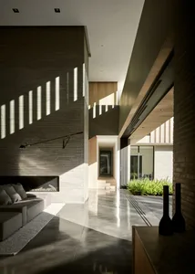 Contemporary living room featuring concrete walls, minimalist furniture, and natural light.