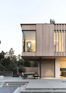 Modern house featuring a wooden exterior and large glass window