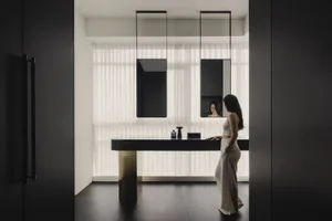 A modern bathroom with glass walls and wooden elements.