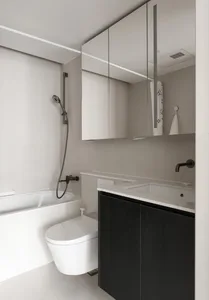 Modern bathroom featuring white porcelain walls and black wooden cabinets.