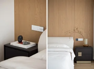 A modern bedroom with clear view of the bed and bedside table.