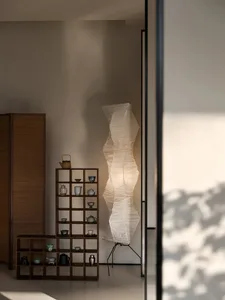 A modern interior design scene featuring a paper floor lamp in a living room setting.