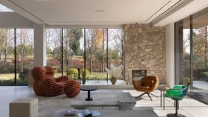 A modern living room featuring stone and glass elements.