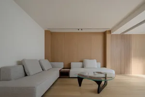 Modern living room with grey fabric sofas and wooden walls