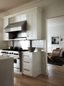Modern kitchen featuring white cabinets, stainless steel appliances, and a clean, minimalistic design.