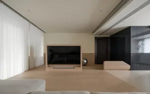 Modern minimalist living room with a wooden floor, a large screen, and a minimalist sofa.