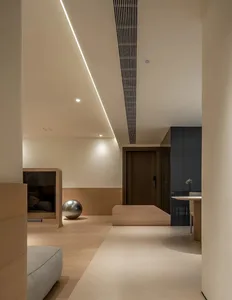 Modern living room with wooden flooring and minimalistic design elements.