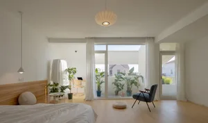 A modern bathroom with wooden accents and a large window overlooking the balcony.