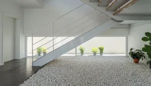 A minimalist, modern interior featuring a concrete floor and white walls.