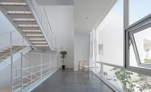 Minimalist white interior featuring concrete and glass elements