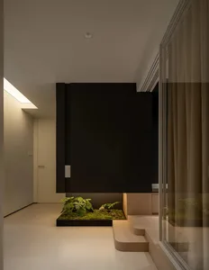 Modern minimalist interior design featuring concrete flooring and walls.