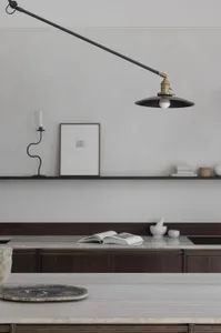 A minimalist kitchen featuring marble countertops and wooden cabinets.