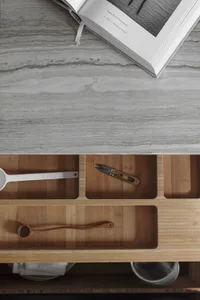 A modern kitchen countertop with decorative storage compartments made of bamboo