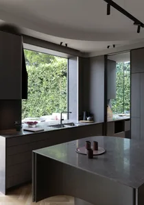 A sleek, minimalist kitchen featuring modern stone interior design.