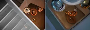 Multiple pendant lights suspended from a ceiling, featuring a warm, contemporary design with metallic finishes.