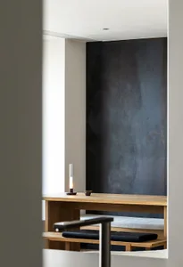 A minimalist interior design featuring wooden furniture and leather accents.