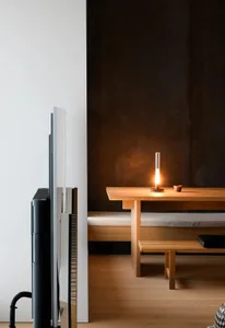 A photograph showcasing a minimalist residential interior featuring industrial-style timber and metallic elements.