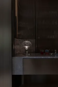 A sleek, modern bar counter featuring a glass lamp with a unique design.
