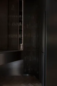Modern interior design featuring a contemporary pantry cabinet with metal perforated panel.