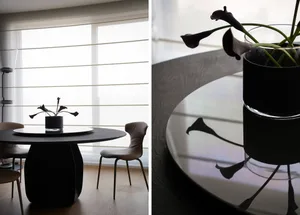 Modern dining room featuring a sleek, black metal dining table with three matching chairs.