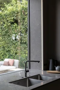Modern kitchen with marble countertop and stainless steel sink