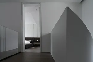 A modern bedroom featuring minimalist design with hidden contours, made from wood, glass, and concrete materials.