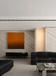 Modern living room with marble elements and sleek, black furniture.